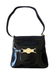 1970s GCCI saddle bag in black leather with muted gold hardware, an expandable bottom, wide shoulder strap, and burgundy leather lining