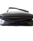 1970s GCCI saddle bag in black leather with muted gold hardware, an expandable bottom, wide shoulder strap, and burgundy leather lining